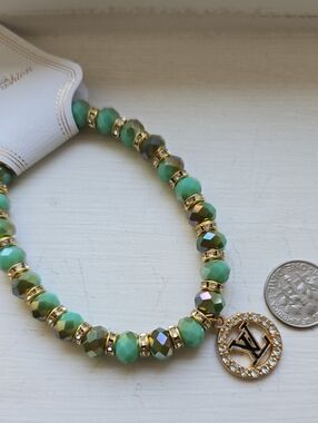 Green Beaded Charm Bracelet with Gold Logo